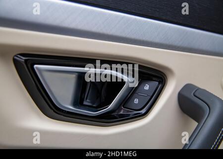 door lock button on a door handle in a modern car Stock Photo