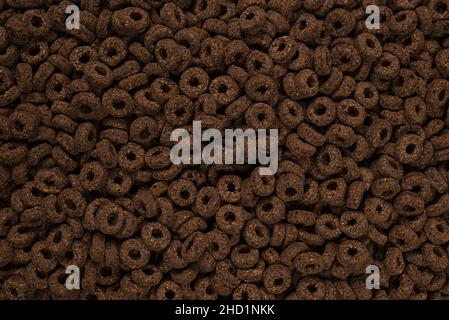 Corn-flakes background and texture. Chocolate rings. Stock Photo