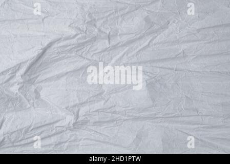 Crumpled white paper background. Top view. Copy space. Stock Photo