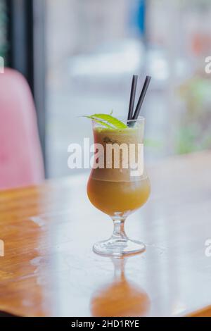 Vertical shot of a tasty cocktail on the wooden table Stock Photo