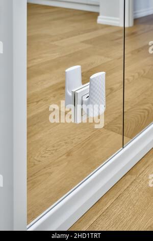 Stylish wi-fi repeater device plugged into outlet on elegant mirrored wall in contemporary luxury apartment extreme close view Stock Photo