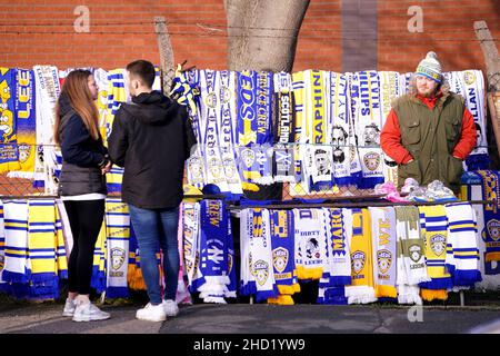 A vendor sells Leeds United scarves outside of the stadium ahead of the Premier League match at Elland Road, Leeds. Picture date: Sunday January 2, 2022. Stock Photo