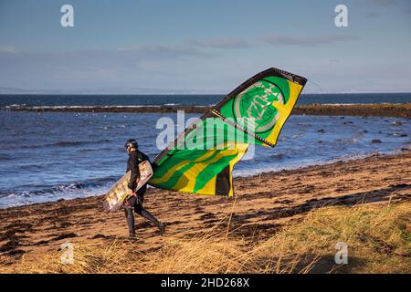 Longniddry, East Lothian, Scotland, UK. 2nd January 2022. Gusty wind at 20 km/h with potential gusts of 35 km/h temperature of 8 degrees for the few kitesurfers who ventured out on the choppy Firth of Forth. Conditions gave good potential for the experienced surfers to get some good air. Credit: Arch White Stock Photo