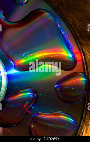 Top view of big water drops on the disc surface creating a rainbow colors effect Stock Photo