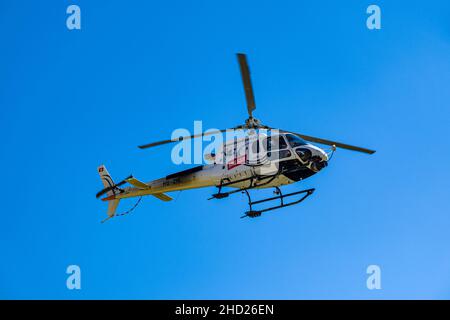 A helicopter with race officials flying over the Tremola San Gottardo at the Tour de Suisse 2021. Stock Photo