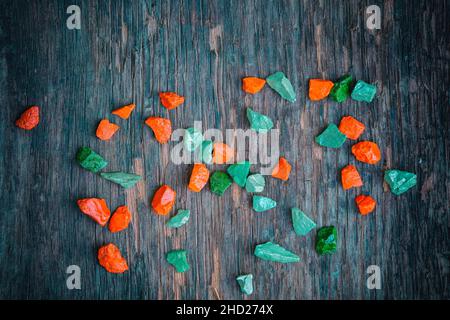 Colorful painted stones on grunge gray wooden background Stock Photo