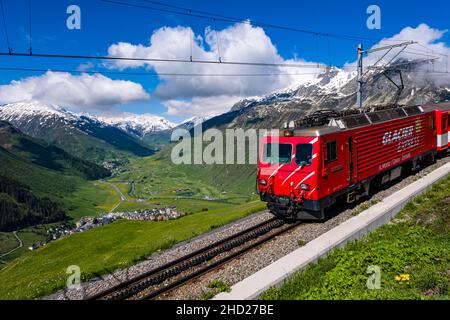 The train Glacier Express, connecting the two major mountain resorts of Zermatt and St. Moritz via Andermatt in the central Swiss Alps. Stock Photo