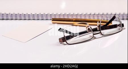 Golden pen notebook and glasses in composition in black and white and golden. Business concept Stock Photo