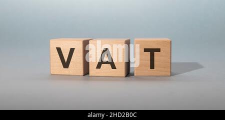 VAT inscription on wooden cubes on grey background Stock Photo