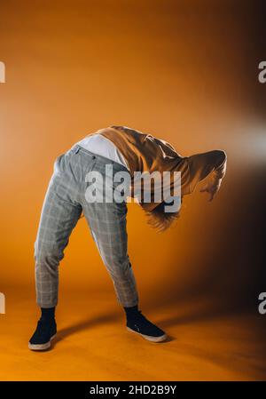 Muscular dance performer practicing dance moves at the studio Stock Photo