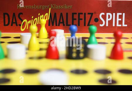 Viersen, Germany - May 9. 2021: View on yellow gameboard with colorful figures and dice  of ravensburger old strategy board game malefiz Stock Photo
