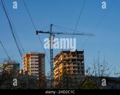 A building that is under construction with a crane near it Stock Photo