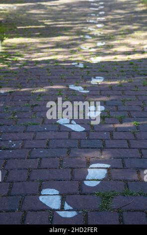 Painted footprints pattern on the pavement Stock Photo