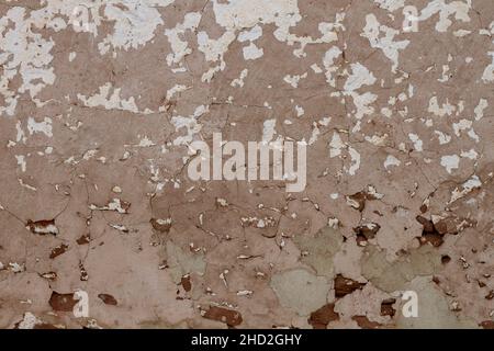 Old distressed traditional limewashed stone wall with peeling plaster, white rustic background or texture Stock Photo
