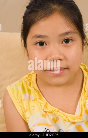 Vietnamese American family at home, portrait of 8 year old girl Stock Photo