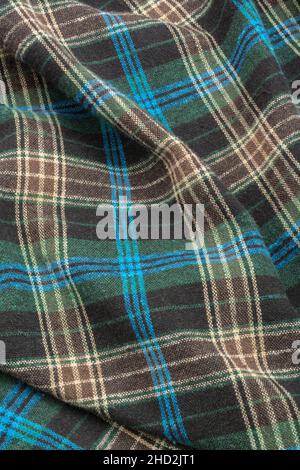 Close-up of blue check flannel fabric, showing warp and weft pattern thread pattern and blue stitching. Stitched line, lines of stitches. Stock Photo