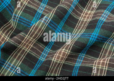 Close-up of blue check flannel fabric, showing warp and weft pattern thread pattern and blue stitching. Stitched line, lines of stitches. Stock Photo