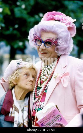 Australian comedy actor Barry Humphries as Dame Edna Everage with Emily Perry as Madge in London 1989 Stock Photo