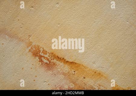 Ceramic porcelain stoneware wall tile detail with textured natural sandstone finish and rust stains Stock Photo