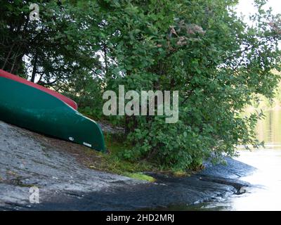Two canoes beached on shore Stock Photo