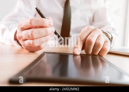 Employer offers stylus pen for electronic signature or e-sign of employment contract agreement in office, selective focus Stock Photo