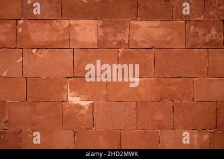 Reddish brown decorative claystone brick wall background Stock Photo