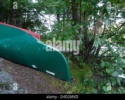 Two canoes beached on shore Stock Photo