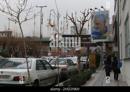 (220102) -- TEHRAN, Jan. 2, 2022 (Xinhua) -- People walk past a billboard showing late Iranian General Qassem Soleimani in Tehran, Iran, on Jan. 2, 2022, one day ahead of the second anniversary of his assassination by the United States in Iraq. Iran's Foreign Ministry said on Sunday that the U.S. assassination of the country's top general two years ago has raised 'hatred' in global opinion. A U.S. airstrike on Jan. 3, 2020 killed Soleimani, former commander of the Quds Force of Iran's Islamic Revolution Guards Corps, along with an Iraqi militia commander, near the Baghdad International Airport Stock Photo