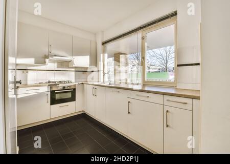 Bright kitchen with a luxury kitchen island in the elegant house Stock Photo