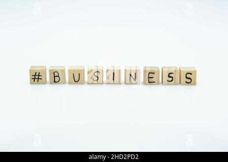 Word Business written on the wood cubes on white  background. The concept photo with letters #business Stock Photo