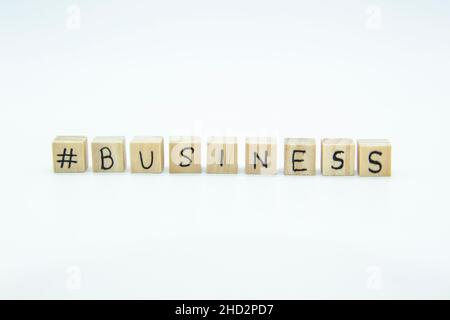Word Business written on the wood cubes on white  background. The concept photo with letters #business Stock Photo