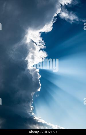 Rays Of Sunlight Shine Through Heavy Grey Clouds Stock Photo