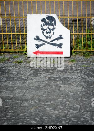 Sign With Skull ,Pirate Emblem And Directional Arrow On A Fence Stock Photo