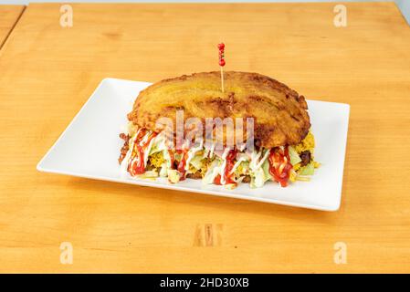 The Venezuelan patacón is flattened and fried green plantain, very popular and can be consumed with fish, chicken or shredded meat, generally it is ac Stock Photo