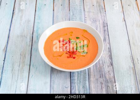 Gazpacho is a cold soup with various ingredients such as olive oil, vinegar, water, raw vegetables, usually cucumbers, peppers, onions and garlic. Stock Photo