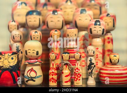 tokyo, japan - october 14 2021: A lot of traditional hand painted wooden Japanese dolls with no arms or legs from all around Japanese regions in the e Stock Photo