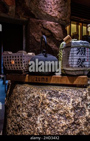 United States / USA / New York /Japanese sake kinkon barrel with iron cast teapot at the elegant Zuma Restaurant New York Madison Avenue. Stock Photo