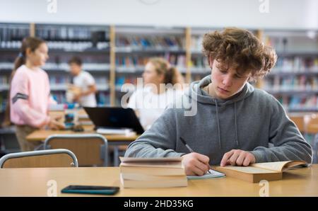 Teenage boy and library Stock Photo