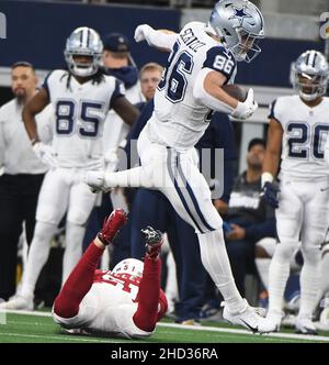 Arlington, United States. 02nd Jan, 2022. Dallas Cowboys Dalton Schultz leaps over a Arizona Cardinals player during their NFL game at AT&T Stadium in Arlington, Texas on Sunday, January 2, 2022. Photo by Ian Halperin/UPI Credit: UPI/Alamy Live News Stock Photo