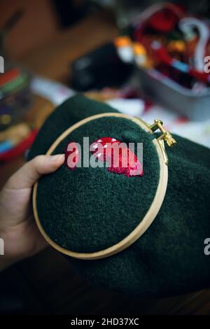 Girl's hand embroidery mushroom hat in hoop. Stock Photo