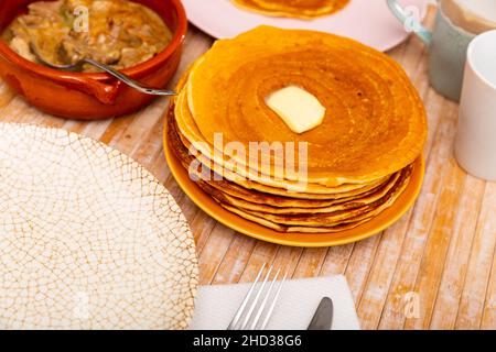 Pancakes with butter and mochanka of meat and mushrooms Stock Photo