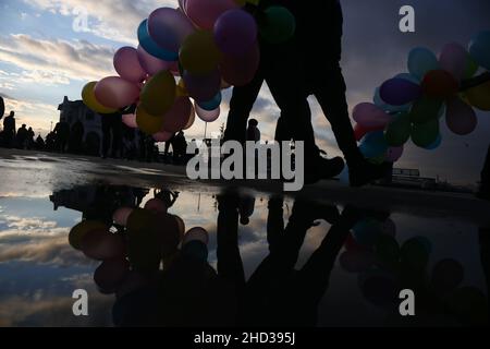 Istanbul, Turkey. 02nd Jan, 2022. Silhouettes of people reflected in the puddle of water after rainfall. Credit: SOPA Images Limited/Alamy Live News Stock Photo