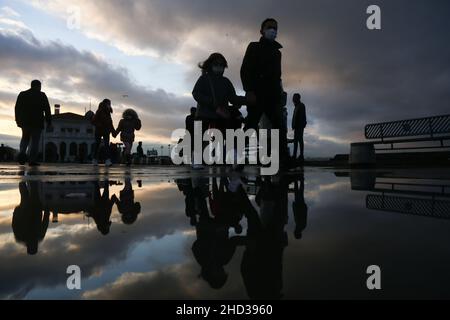 Istanbul, Turkey. 02nd Jan, 2022. Silhouettes of people reflected in the puddle of water after rainfall. Credit: SOPA Images Limited/Alamy Live News Stock Photo