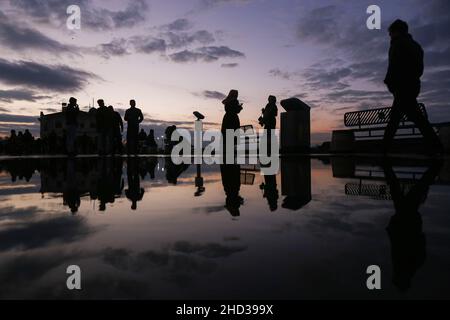 Istanbul, Turkey. 02nd Jan, 2022. Silhouettes of people reflected in the puddle of water after rainfall. (Photo by Hakan Akgun/SOPA Images/Sipa USA) Credit: Sipa USA/Alamy Live News Stock Photo