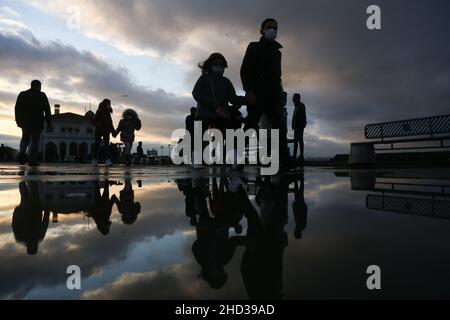 Istanbul, Turkey. 02nd Jan, 2022. Silhouettes of people reflected in the puddle of water after rainfall. (Photo by Hakan Akgun/SOPA Images/Sipa USA) Credit: Sipa USA/Alamy Live News Stock Photo