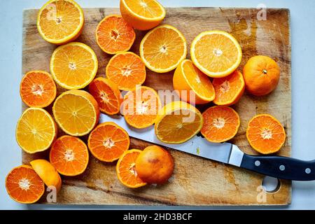 Orange Halves on Chopping Board with Knife Stock Photo