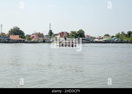 BANGKOK, THAILAND - December 12, 2021: Tourists boat of bangkok crosses the Chao Phraya River. Stock Photo