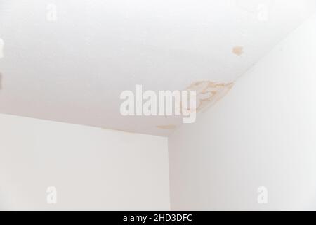 Stains on ceiling and wall from water leak Stock Photo