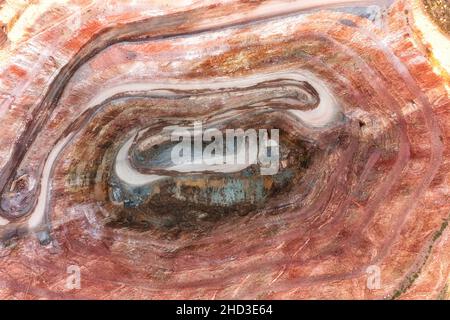 Bottom of open pit copper mine in Cobar town of Australa - aerial top down view. Stock Photo