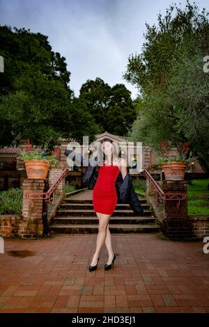 Young Asian Woman in Red Holiday Party Dress Stock Photo